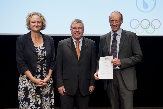IOC President Thomas Bach presents Martin Burke with his certificate.  Also pictures is Leigh Robinson, Martin's tutor on the MEMOS Course